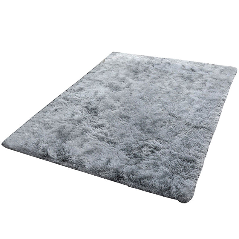 Gray shaggy rug on a white background