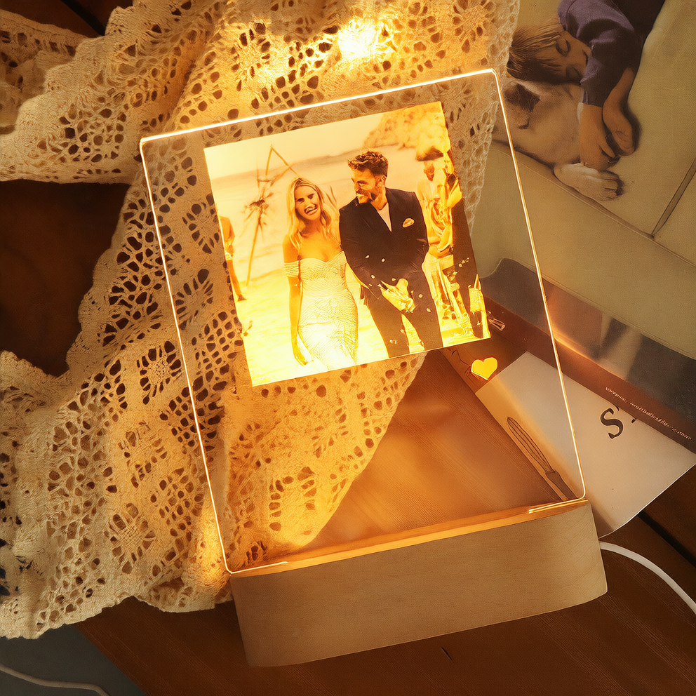 Decorative box with a photo of a couple on a beach, illuminated from within.