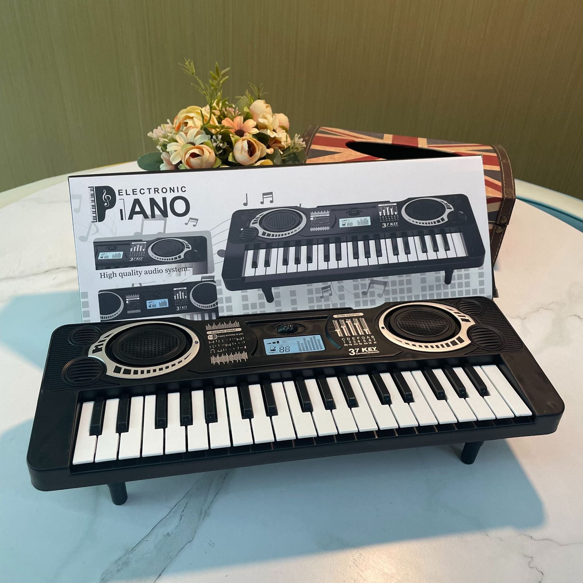 Electronic keyboard with packaging on a marble surface
