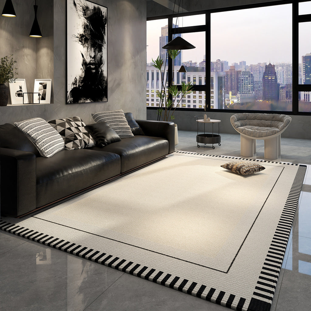 Modern living room with a black leather sofa, rug, and cityscape view.