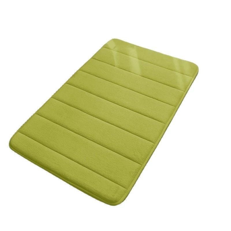 Green bath mat on a white background
