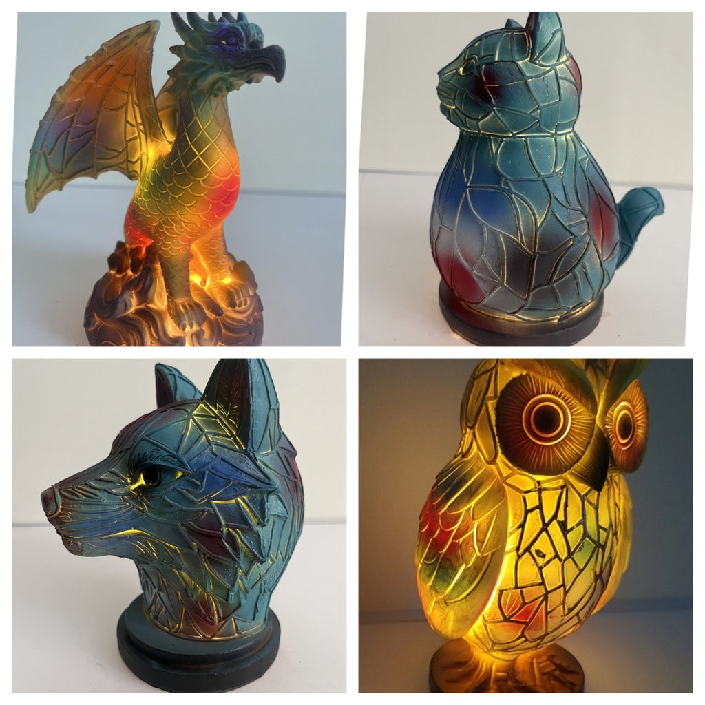 Four animal-shaped lamps with stained glass designs on a white background