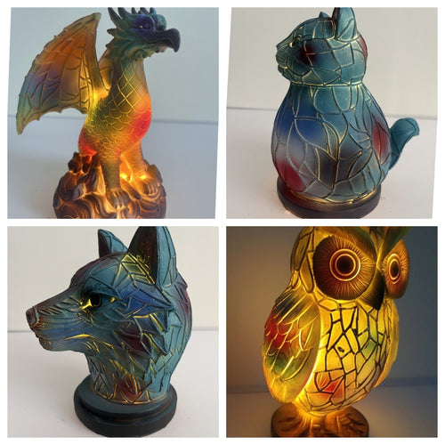 Four animal-shaped lamps with stained glass designs on a white background