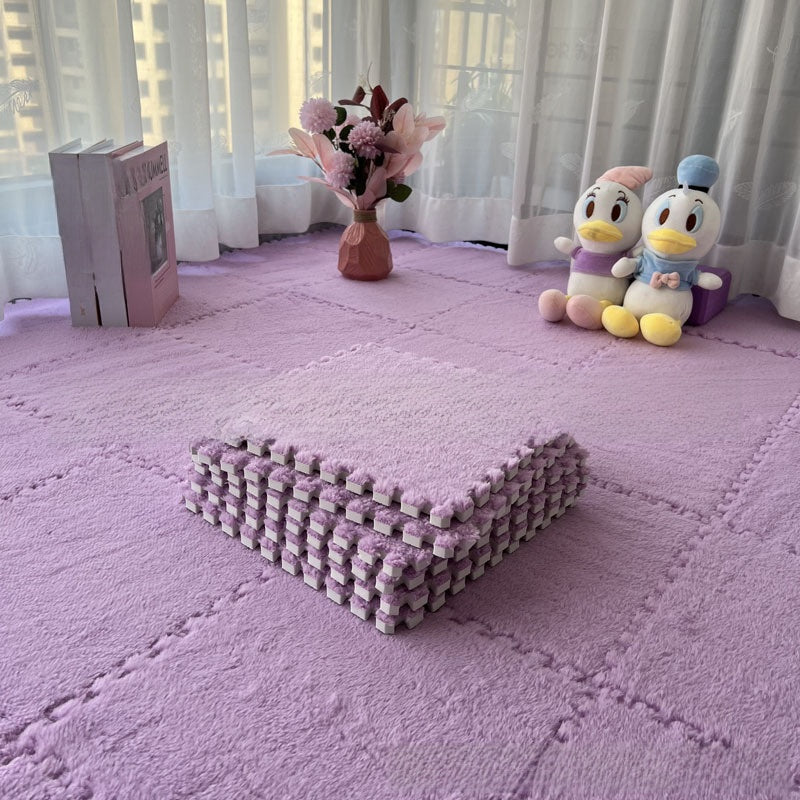 Purple textured mat on a floor with plush toys and flowers in the background
