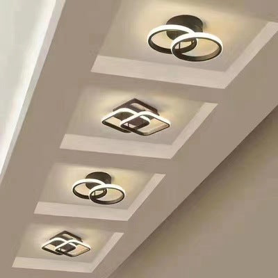 Modern ceiling lights with geometric designs on a ceiling with recessed lighting.