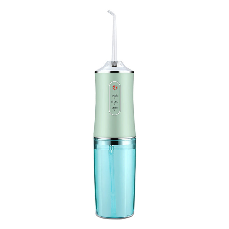 Portable water flosser with a green top and blue bottom on a white background