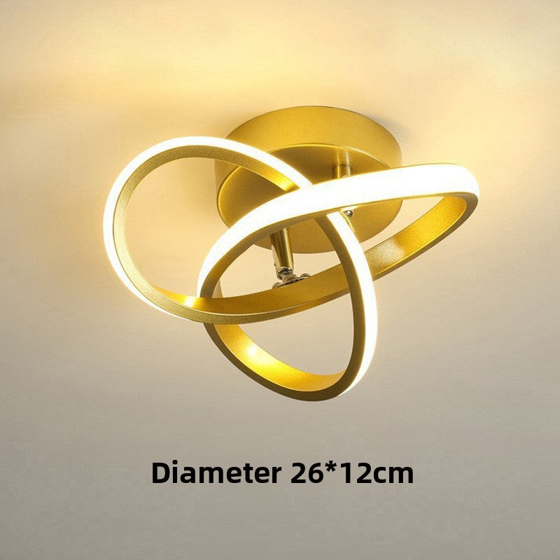 Gold ceiling light fixture with three circular designs on a plain background