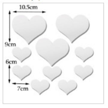 White heart-shaped objects with measurements on a white background