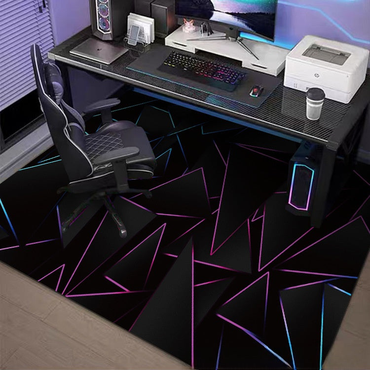 Gaming desk setup with chair, computer equipment, and a colorful geometric-patterned rug.