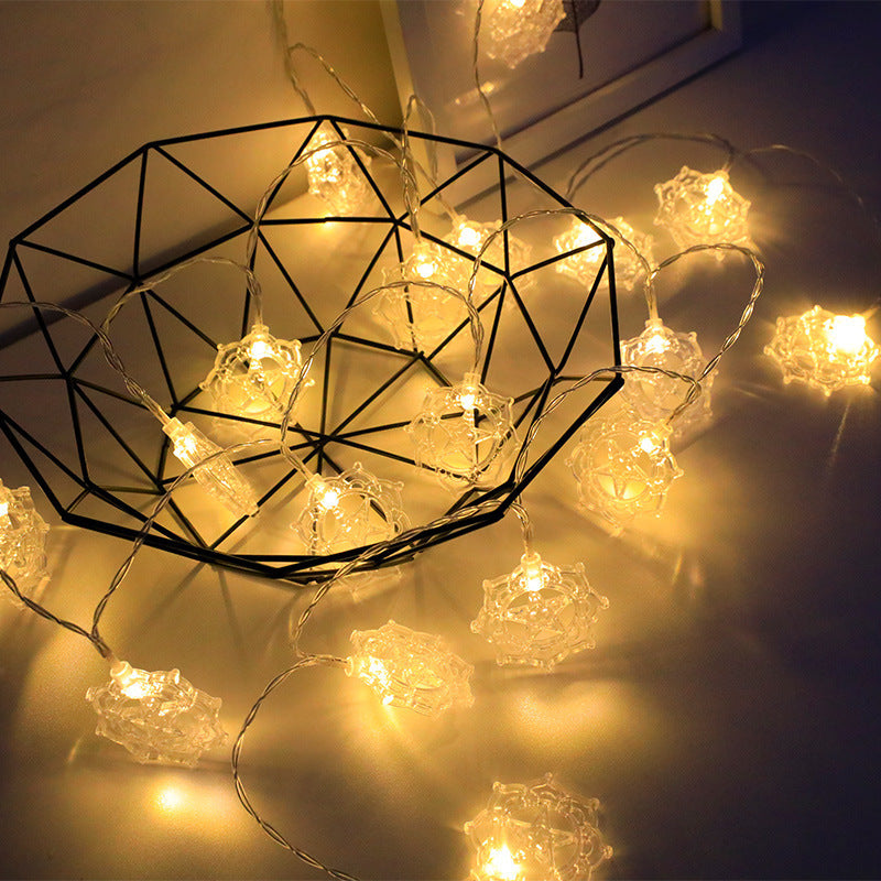 String lights with geometric metal frame on a dark background