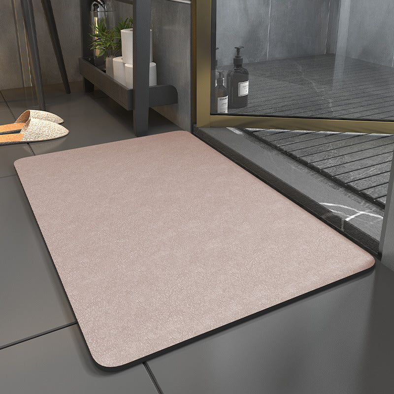 Beige doormat on a tiled floor with a glass door in the background