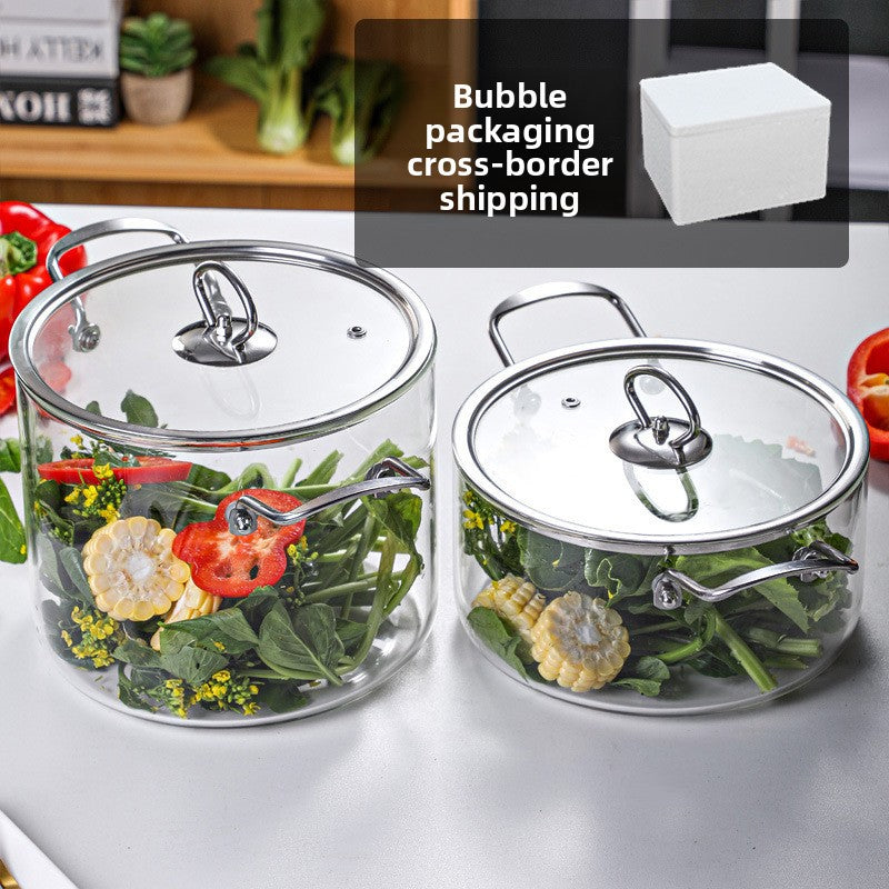 Two glass containers with lids on a white surface, containing vegetables.