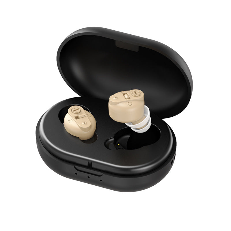 Beige hearing aids in a black charging case on a white background