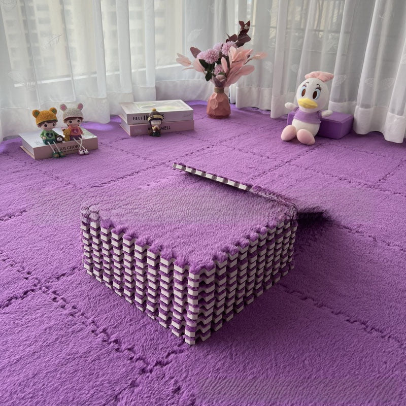 Purple foam puzzle mat with toys and decorative items on a light background