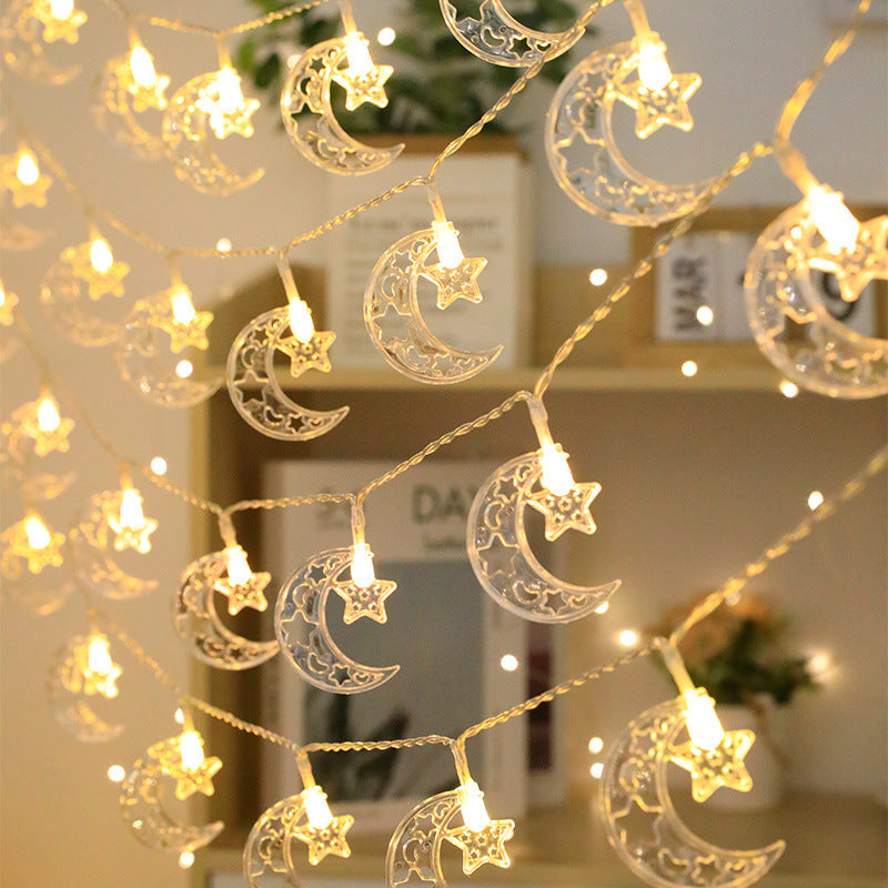 String lights with moon and star designs in a room setting