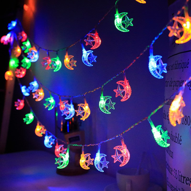 String lights with moon and star designs on a dark background