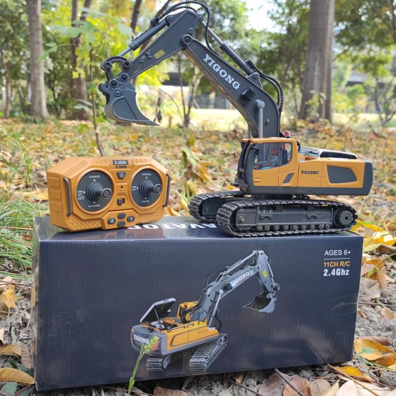 Toy excavator and remote control on a box with a natural background