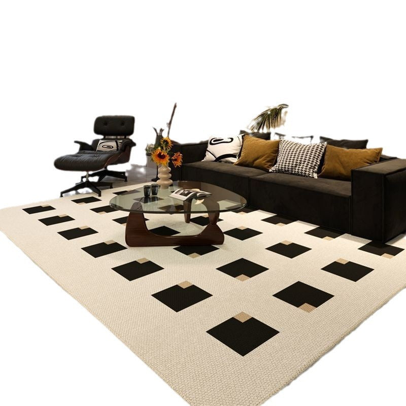 Modern living room with a black and white checkered rug, sofa, and coffee table.