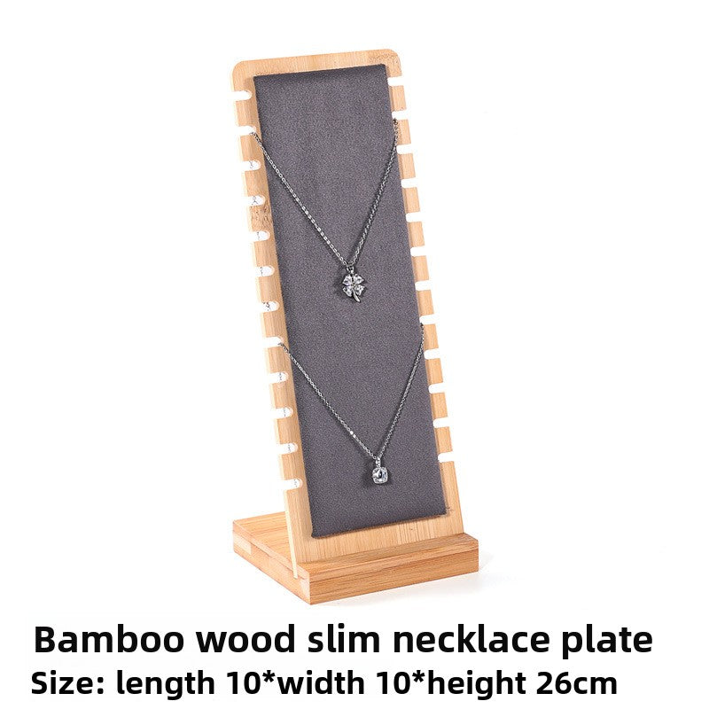 Bamboo wood slim necklace plate with a necklace on a white background