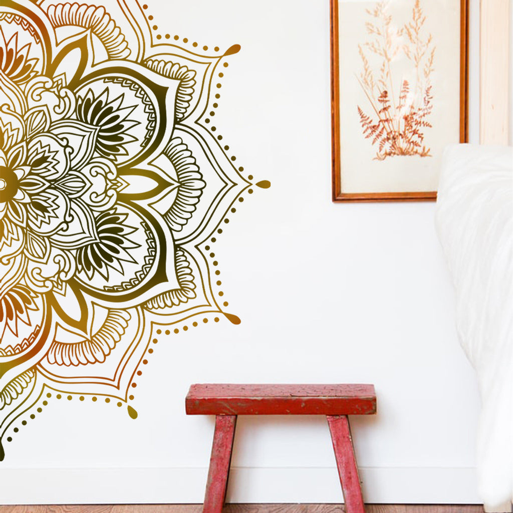 Decorative wall decal with intricate patterns on a white wall, accompanied by a red stool.
