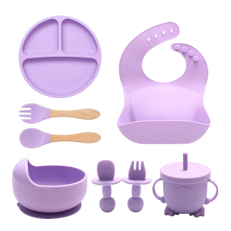 Purple children's dining set including plate, bib, utensils, and cup on a white background