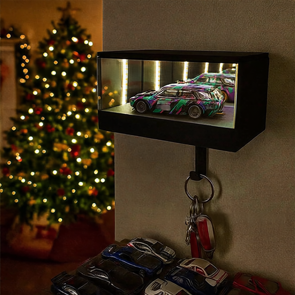 Decorative display case with model cars on a wall next to a Christmas tree.
