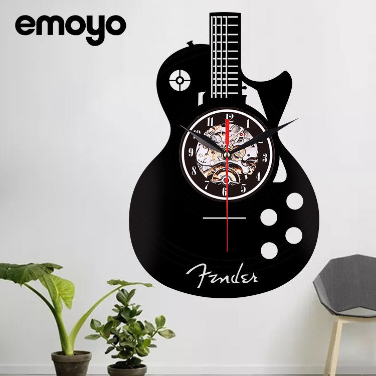 Guitar-shaped wall clock with 'Fender' branding on a white wall, featuring the Emoyo brand.