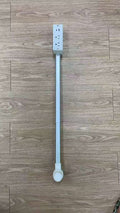 Long white plastic strip with a switch on a wooden floor