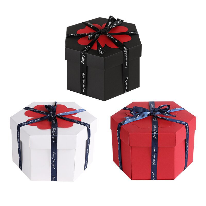 Three hexagonal gift boxes in black, white, and red with decorative ribbons on a white background.
