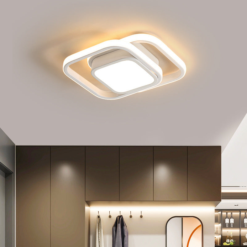Modern ceiling light fixture in a kitchen setting with cabinets and a mirror.