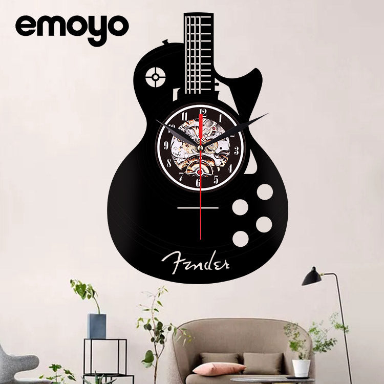 Guitar-shaped wall clock with 'Fender' branding in a living room setting.