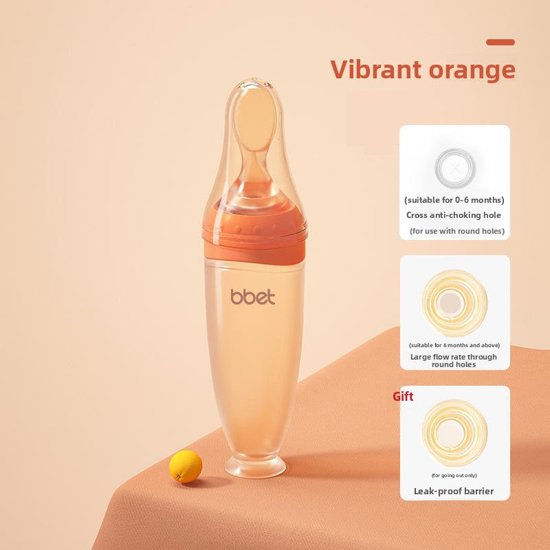 Baby bottle with vibrant orange top on a beige background
