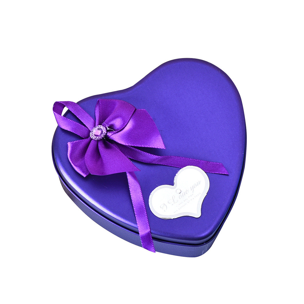 Heart-shaped purple gift box with a bow on a white background