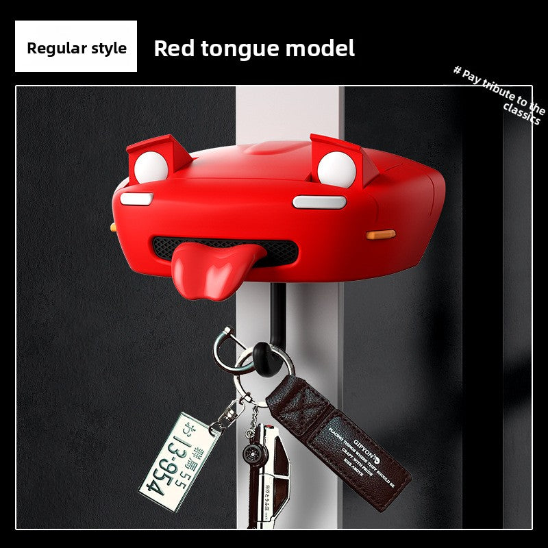 Red car-shaped key holder with a tongue feature on a black background