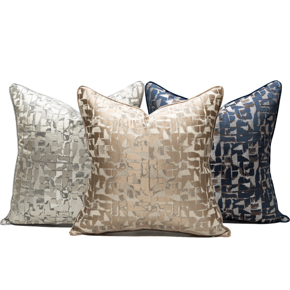 Four patterned pillows on a white background