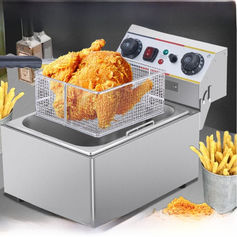 Fried chicken in a deep fryer with fries on the side
