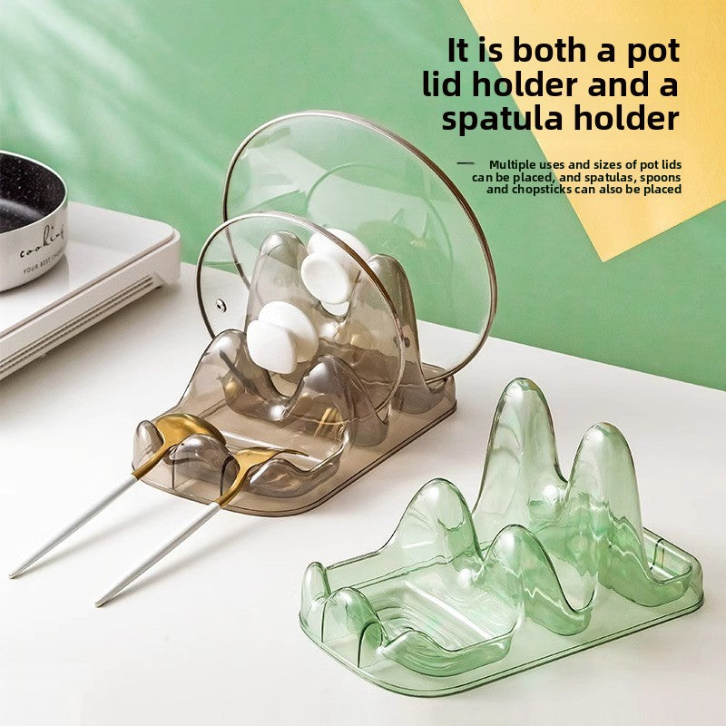 Clear pot lid holder and green spatula holder on a white surface with text description.