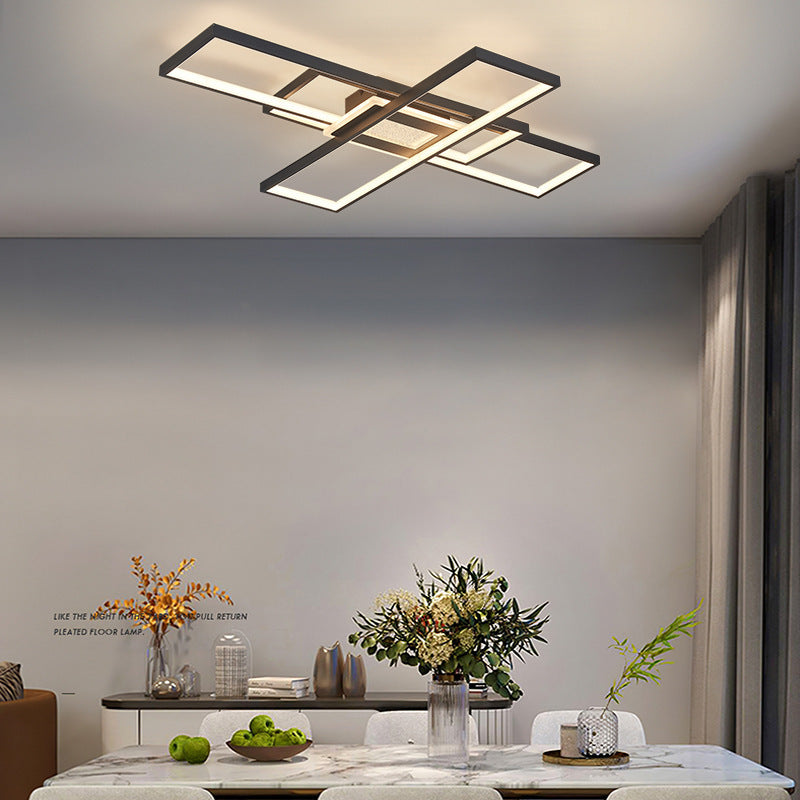 Modern ceiling light fixture in a living room setting with decor elements.
