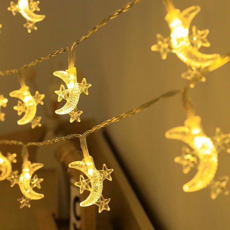 String lights with moon and star designs on a neutral background