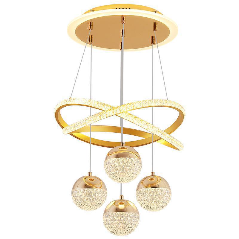 Gold chandelier with circular design and crystal-like spheres on a white background