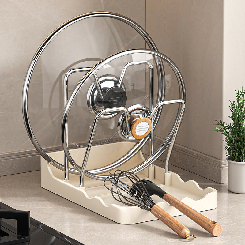 Kitchen utensil holder with ladles, whisk, and spatula on a countertop.