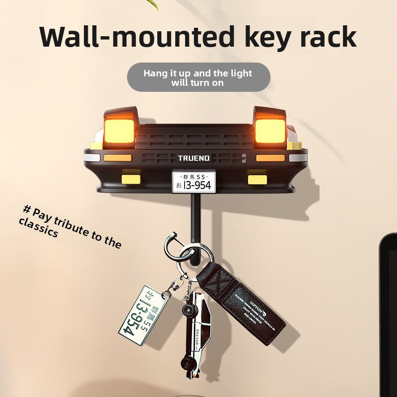Wall-mounted key rack with light feature on a beige background