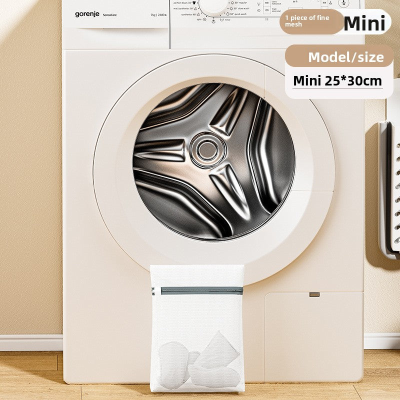 Gorenje dryer with a laundry bag labeled 'Mini' on a wooden floor.