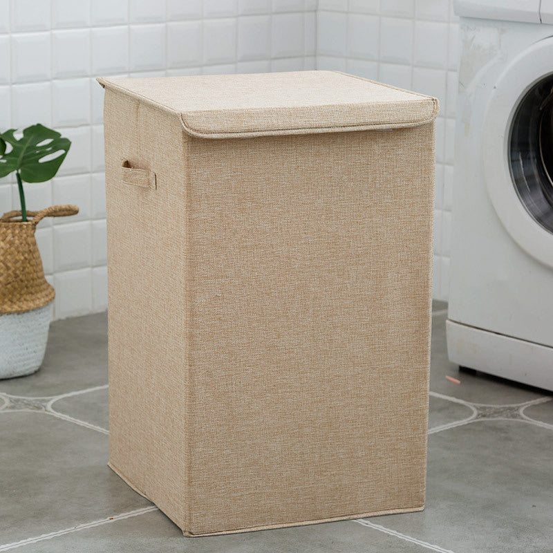 Beige laundry basket on a tiled floor with a washing machine in the background