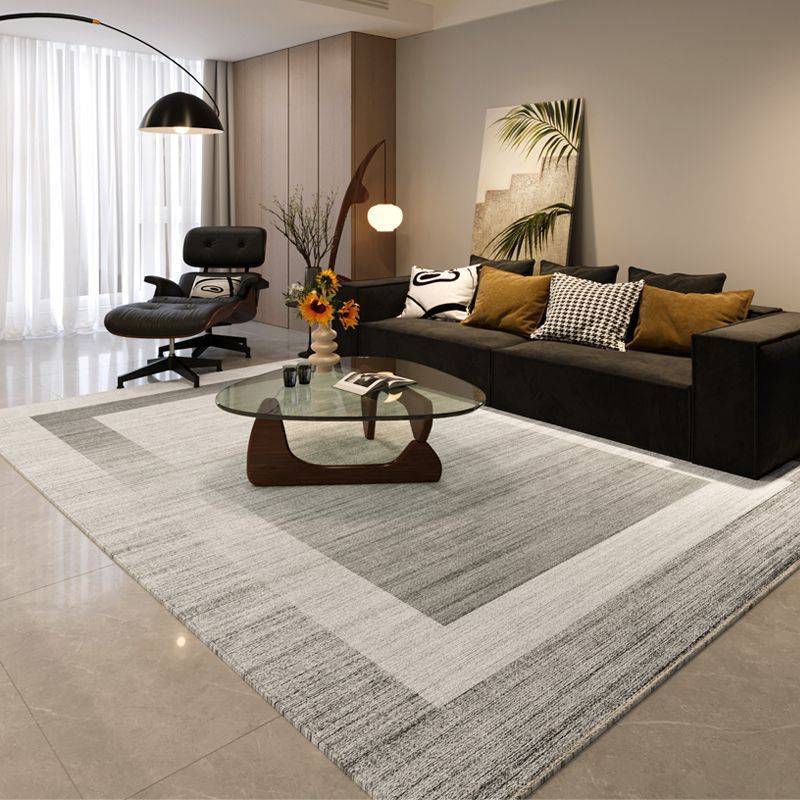 Modern living room with a sectional sofa, coffee table, and decorative elements.