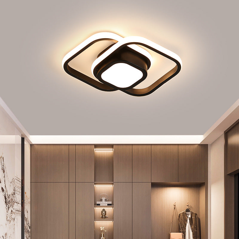 Modern ceiling light fixture in a room with wooden cabinets and decor.