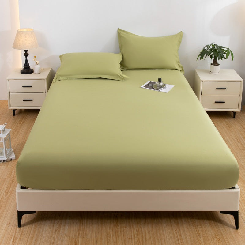 Green bed sheet set on a bed in a bedroom with nightstands and decor.