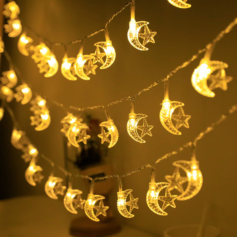 String lights with moon and star designs on a dark background