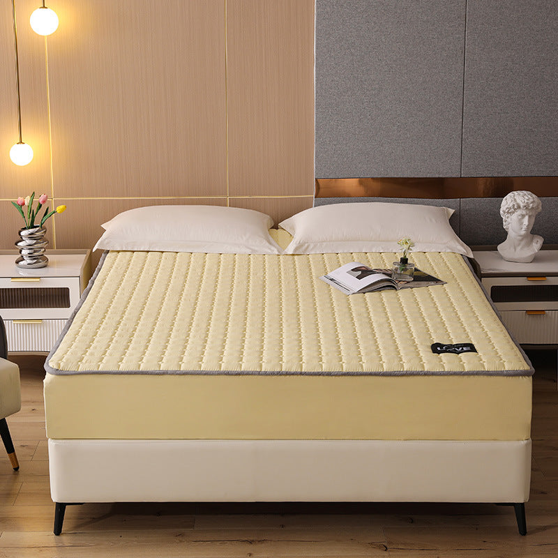 Yellow mattress on a bed in a bedroom setting with decor elements.