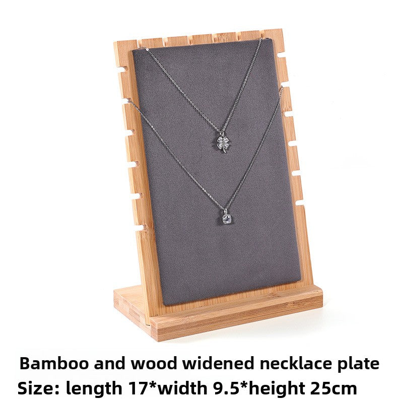 Necklace on a bamboo and wood widened necklace plate with dimensions displayed.